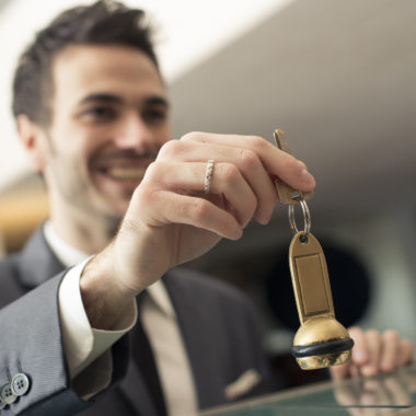 Young businessman doing the check in at the hotel.